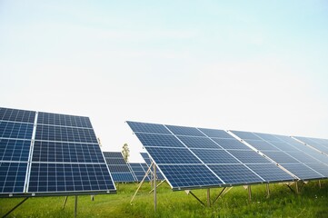 Solar panels energy farm on sky background.