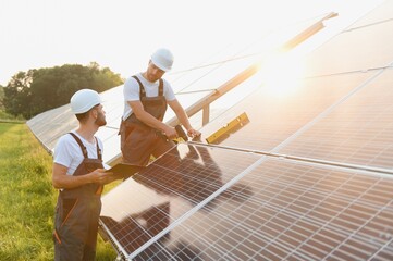 Engineering team working on checking and maintenance in solar power plant, Solar panel technician...