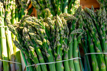Fresh raw green asparagus vegetables in french Provencal farmers market in Arles, France