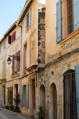 Fototapeta na wymiar View on old streets and houses in ancient french town Arles, touristic destination Roman ruines, Bouches-du-Rhone