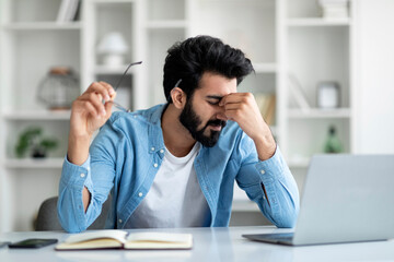 Indian Freelancer Guy Suffering Eyes Fatigue While Working With Laptop At Home