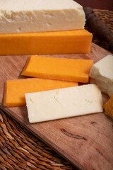 British cheeses collection, Scottish coloured and English matured cheddar cheeses close up