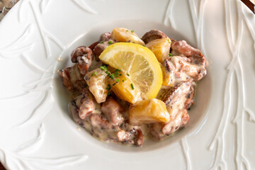 Tastes od Camargue, Provence, hot dish salad with boiled octopus, potatoes and white sauce, served in French restaurant