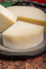 Italian cheese, Provolone dolce cow cheese from Cremona served with olive bread and tomatoes close up