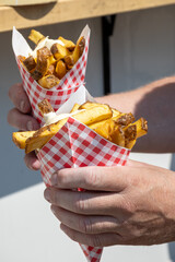 Traditional street food in Belgium and Netherlands, French fried potatoes chips with mayonnaise...