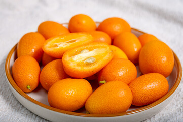 Delicious small citrus fruits orange kumquats close-up