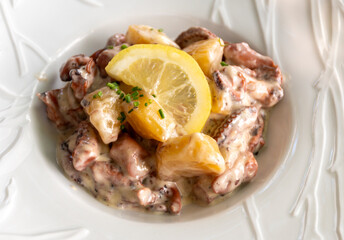 Tastes od Camargue, Provence, hot dish salad with boiled octopus, potatoes and white sauce, served in French restaurant