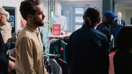 Guard arguing with angry shoppers, working on crowd control during black friday sales launch. Diverse crazy customers at store entrance screaming at security agent, aggressive clients.