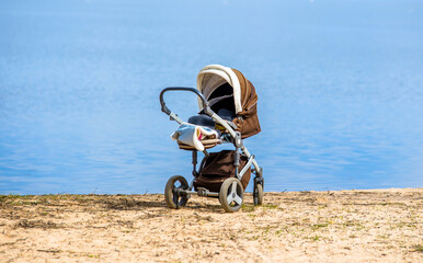 A baby stroller standing on the seashore
