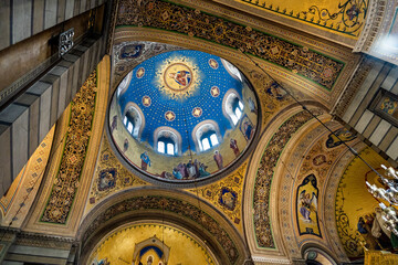 Fototapeta na wymiar Richly-decorated interior of the Saint Spyridon Serbian-Orthodox church, erected in 18th century, with a dome and mosaics in Neo-Byzantine style, Trieste, Italy