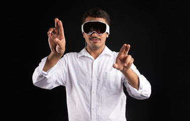 Latin man experiencing virtual reality in modern vision pro vr glasses, interacting with virtual screens gesturing hands