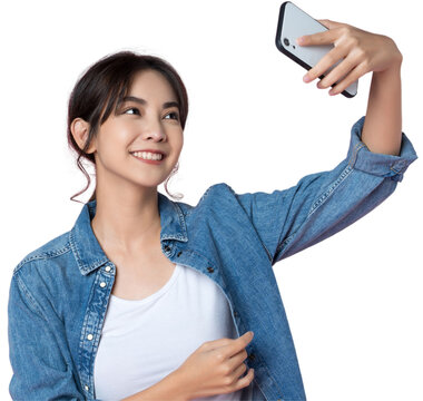 Young Asian woman taking selfie wiith smartphone shoot in isolated background.