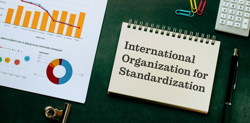 There is notebook with the word International Organization for Standardization. It is as an...