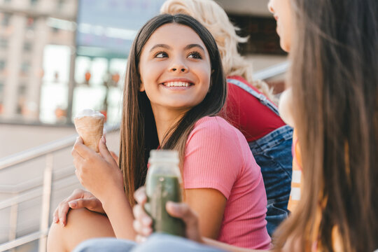 Premium Photo  Multiethnic friends in an ice cream parlor sitting eating  an ice cream summer showing off the ice creams