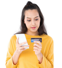 Young beauty Asian woman shopping payment online with credit card on smartphone and she wearing a yellow sweater and looking on camera shot isolated on white background