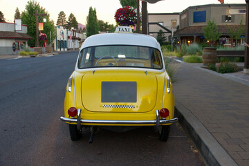 rear view of a parked yellow taxi