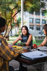 Three students having lunch during a class break in the university