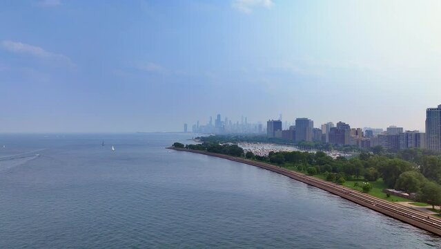 Aerial shot of Chicago, blue sky, lake Michigan, green park, yacht parking, 4k.