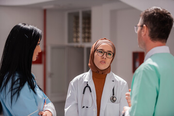 Medical team interacting in the hospital corridor.