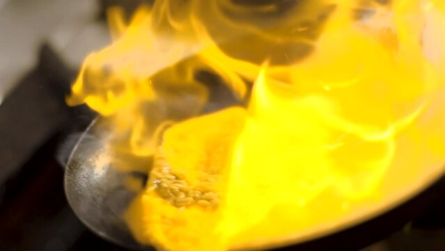 Peruvian tacu tacu flamb&eacute; in wok(flaming), traditional Peruvian food dish, high heat, delicious, Slow motion