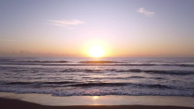 Stationary footage of a sunrise on the beach. Guarapari, Espirito Santo, Brazil.
