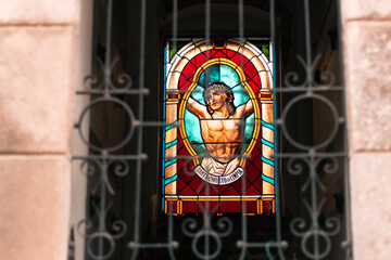 view of image of christ in a mausoleum altar in an outdoor cemetery park.