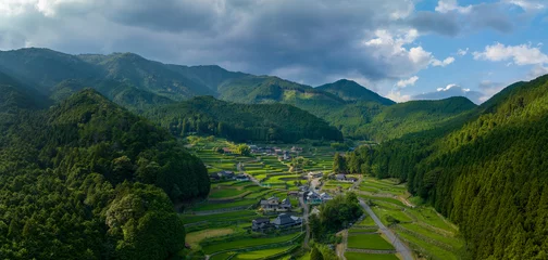 Fotobehang Rijstvelden Terraced rice fields of traditional farming village in green mountains