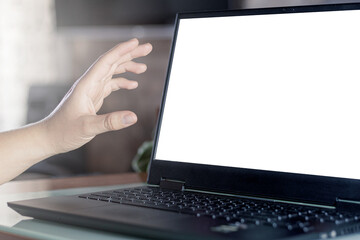 Unrecognizable person browsing the web and interacting with something on his laptop screen. Blank screen, social media advertising, e-commerce, digital marketing concept.