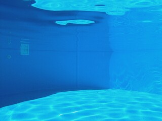 Blue swimming pool under water 