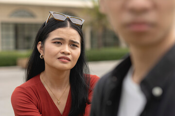 A young asian woman realizing her loss after her good boyfriend says goodbye and leaves her. A...