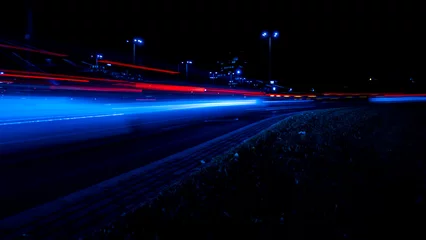 Cercles muraux Autoroute dans la nuit Lights of cars at night. Street line lights. Night highway city. Long exposure photograph night road. Colored bands of red light trails on the road. Background wallpaper defocused photo. 