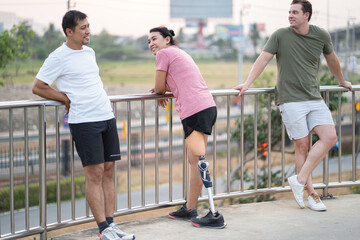Exercise Asia woman with prosthetic leg and friend in the park city	