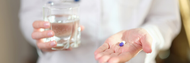 Woman doctor offers to take pill for cure illness.
