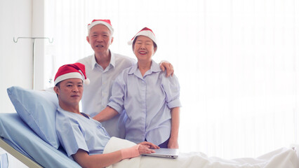 Asian family celebrating Christmas and New Year in hospital kid admit recovery good family relationship