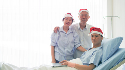 Asian family celebrating Christmas and New Year in hospital kid admit recovery good family relationship