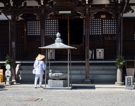 Saijo, Ehime prefecture, Japan - April 12, 2018: O-henro Buddhist pilgrim in white robes at Kichijoji, temple number 63 of Shikoku pilgrimage