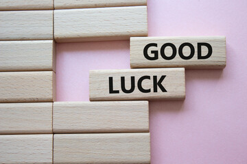Good luck symbol. Wooden blocks with words Good luck. Beautiful pink background. Business and Good luck concept. Copy space.