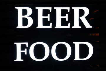 The inscription or poster food and beer at the entrance to a bar or cafe. White letters on a black background