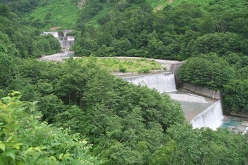 Fototapeta na wymiar Toyama,Japan - July 16, 2023: Check dam or Sabo dam on Shomyo river, Toyama, Japan 
