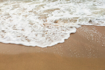 Fototapeta na wymiar Sea Wave on the Sand Beach Close Up Background