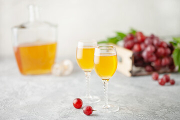 Grape vodka. Strong alcoholic drink in glasses on the table. Fresh grapes