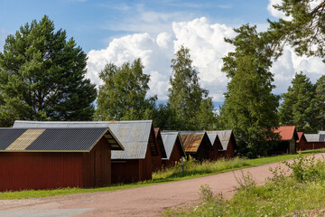 Obraz premium Nusnas, Sweden Small red boat houses on the shore of Lake Siljan.