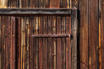 Nusnas, Sweden A weathered red barn door and facade.