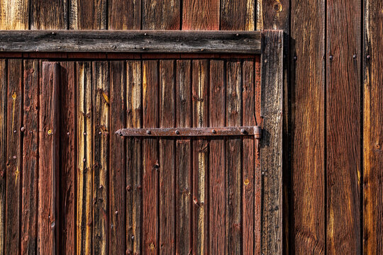 Nusnas, Sweden A weathered red barn door and facade.