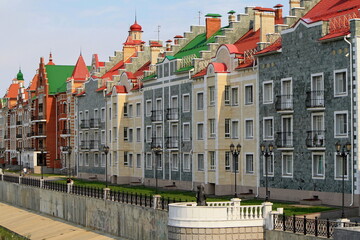 Fototapeta na wymiar Yoshkar-Ola, Republic of Mari El, Russia - 08.20.2021. Buildings on the Bruges embankment