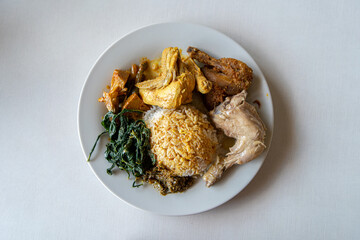 Nasi Padang with Fried Chicken, Chicken Gule, Chicken Pop is an Indonesian food from West Sumatra in Indonesia. Nasi Padang as favorites food for Indonesian people.