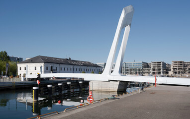 Fototapeta premium Estonia's dynamic, movable Admiral pedestrian bridge made with steel and durable composite, in Old City Harbor in the Port of Tallinn