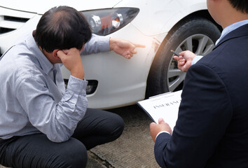Loss Adjuster Insurance Agent Inspecting Damaged Car selective focus.