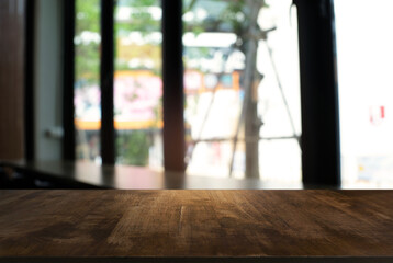 Empty dark wooden table in front of abstract blurred bokeh background of restaurant . can be used for display or montage your products.Mock up for space.