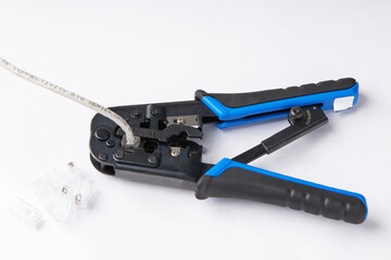Modular plug crimper for Network or ethernet cable on white background.